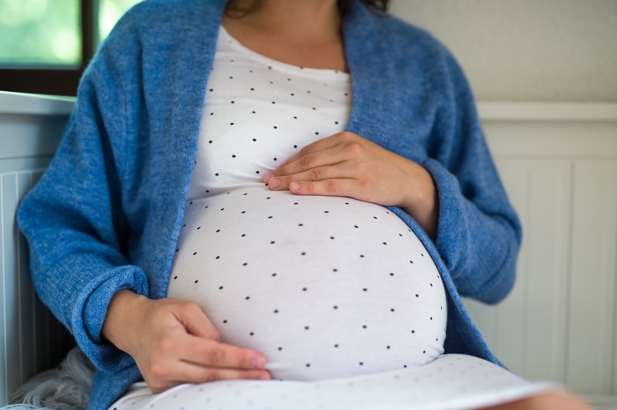 Gravid kvinde holder sig på maven